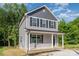 Two-story home with gray siding, black shutters, and a covered front porch at 304 Adams St, Salisbury, NC 28144