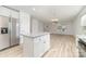Open-concept kitchen and living area with stainless steel refrigerator and granite island at 304 Adams St, Salisbury, NC 28144