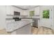 Bright kitchen featuring white cabinets, stainless steel appliances, granite counters and an island at 304 Adams St, Salisbury, NC 28144
