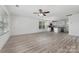Open living room featuring neutral walls, wood-look flooring, a ceiling fan and lots of natural light at 304 Adams St, Salisbury, NC 28144