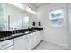 Clean bathroom with a double sink vanity, large mirror, and natural light at 4005 Easton Ridge Ln, Charlotte, NC 28226