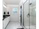 Well-lit bathroom featuring a glass shower, double vanity, and marble-look tile at 4005 Easton Ridge Ln, Charlotte, NC 28226