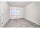 Simple bedroom with natural light from the window and soft carpet at 4005 Easton Ridge Ln, Charlotte, NC 28226