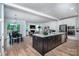 Open-concept kitchen with stainless steel appliances and a large island overlooking the living room at 4005 Easton Ridge Ln, Charlotte, NC 28226