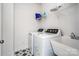 Functional laundry room featuring modern washer, dryer, sink, and storage shelves at 4005 Easton Ridge Ln, Charlotte, NC 28226