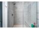 Glass enclosed shower featuring marble-look tile and shower bench at 4005 Easton Ridge Ln, Charlotte, NC 28226