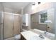 Clean bathroom featuring a shower, vanity, and window providing natural light at 403 Cherrywood Ln, Albemarle, NC 28001