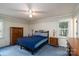 Relaxing bedroom with ceiling fan, blue carpet and comfortable furnishings with plenty of natural light at 403 Cherrywood Ln, Albemarle, NC 28001
