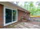 Back deck with sliding glass door to brick home exterior at 403 Cherrywood Ln, Albemarle, NC 28001
