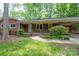 Close up of the home's brick facade and charming front porch with decorative columns at 403 Cherrywood Ln, Albemarle, NC 28001