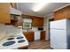 Traditional kitchen featuring wood cabinets, white appliances, and updated flooring at 403 Cherrywood Ln, Albemarle, NC 28001