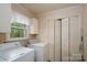 Functional laundry room with washer, dryer, and plenty of closet space for storage solutions at 403 Cherrywood Ln, Albemarle, NC 28001
