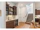Stylish bar area with a sink, wine cooler, and custom cabinetry near the stairs at 4108 Commonwealth Ave, Charlotte, NC 28205