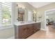 Elegant bathroom featuring double vanity with modern fixtures, mirrors, and tiled flooring at 4108 Commonwealth Ave, Charlotte, NC 28205