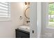 Modern half bathroom featuring a sleek vanity, vessel sink, and stylish round mirror at 4108 Commonwealth Ave, Charlotte, NC 28205