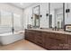 Luxurious bathroom with double vanity, soaking tub, modern fixtures, and elegant tile flooring at 4108 Commonwealth Ave, Charlotte, NC 28205