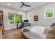 Bright bedroom with a ceiling fan, desk, and large windows offering an outside view at 4108 Commonwealth Ave, Charlotte, NC 28205