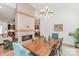 Open dining area with fireplace, stylish lighting fixture, and hardwood floors, flowing into the living space at 4108 Commonwealth Ave, Charlotte, NC 28205