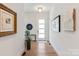 Inviting entryway with light hardwood floors, white walls, and modern artwork at 4108 Commonwealth Ave, Charlotte, NC 28205