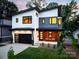 Stunning modern home with a two-car garage and a welcoming front porch with two chairs at 4108 Commonwealth Ave, Charlotte, NC 28205