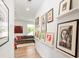 Hallway view showcases stylish gallery wall with art and leads into the well-lit living area at 4108 Commonwealth Ave, Charlotte, NC 28205