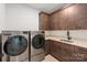 Well-organized laundry room featuring front-load machines and ample storage at 4108 Commonwealth Ave, Charlotte, NC 28205