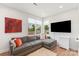 Inviting living room features a gray sofa with bright pillows, natural light, and a modern TV at 4108 Commonwealth Ave, Charlotte, NC 28205