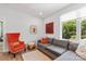 Cozy living room featuring a comfortable gray sofa, accent chair, and stylish decor at 4108 Commonwealth Ave, Charlotte, NC 28205