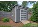 Well-maintained backyard shed with double doors and transom windows, providing ample storage space at 4108 Commonwealth Ave, Charlotte, NC 28205
