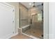 Walk-in shower showcasing large tiles, a glass enclosure, and a built-in bench at 4108 Commonwealth Ave, Charlotte, NC 28205