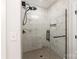 Contemporary shower featuring marble-style tile walls and a glass door at 4108 Commonwealth Ave, Charlotte, NC 28205