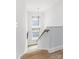 A modern staircase with a wooden handrail and treads, bright lighting, and neutral colors at 4108 Commonwealth Ave, Charlotte, NC 28205