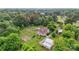 An aerial view of the home, surrounded by lush greenery, with barns and outbuildings at 4335 E Nc 10 Hwy, Claremont, NC 28610