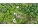 An aerial view of the property, with barns and outbuildings, nestled amongst a thick tree line at 4335 E Nc 10 Hwy, Claremont, NC 28610