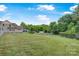 Expansive backyard with lush lawn, fenced perimeter, and mature trees offering privacy at 4335 E Nc 10 Hwy, Claremont, NC 28610