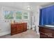 Bathroom features a wood cabinet, neutral walls, tile flooring and a shower with blue curtain at 4335 E Nc 10 Hwy, Claremont, NC 28610