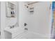 Bright bathroom with white tile walls, shower with curtain, and white fixtures at 4335 E Nc 10 Hwy, Claremont, NC 28610