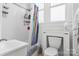 Bright bathroom with white tile walls, shower with curtain, and white fixtures at 4335 E Nc 10 Hwy, Claremont, NC 28610