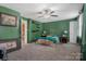 Bedroom features green walls, a ceiling fan and carpeting at 4335 E Nc 10 Hwy, Claremont, NC 28610