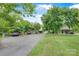Long driveway leading to the home with carport, mature trees, and lush greenery at 4335 E Nc 10 Hwy, Claremont, NC 28610