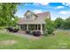 Beautiful two-story home with a well-manicured lawn, mature trees, and fenced yard at 4335 E Nc 10 Hwy, Claremont, NC 28610
