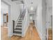 Hallway with staircase, wood floors, and a vintage light fixture at 4335 E Nc 10 Hwy, Claremont, NC 28610