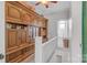 Hallway features decorative wood shelves, white railings and leads to a bathroom at 4335 E Nc 10 Hwy, Claremont, NC 28610