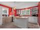 Bright kitchen with red walls, stainless steel appliances, and a butcher block island at 4335 E Nc 10 Hwy, Claremont, NC 28610