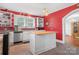 Bright kitchen with red walls, stainless steel appliances, and a butcher block island at 4335 E Nc 10 Hwy, Claremont, NC 28610