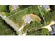 Aerial shot of wooded property showcasing the homesite, driveway and surrounding landscape at 4660 Gold Finch Dr, Denver, NC 28037