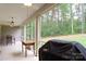 Relaxing screened porch with ceiling fan and Weber grill, perfect for outdoor cooking and entertaining at 4660 Gold Finch Dr, Denver, NC 28037