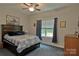Relaxing bedroom with a large window and a dark wood bedframe at 4660 Gold Finch Dr, Denver, NC 28037