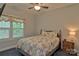 Comfortable bedroom features a quaint window with floral valance and a ceiling fan at 4660 Gold Finch Dr, Denver, NC 28037