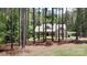 Inviting home partially obscured by tall trees, offering a sense of privacy and tranquility at 4660 Gold Finch Dr, Denver, NC 28037